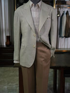 Apricot-colored linen single-breasted suit with a drawstring hem and twill pattern