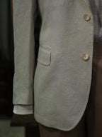Apricot-colored linen single-breasted suit with a drawstring hem and twill pattern